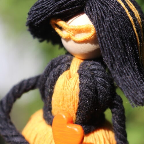 macrame doll black orange