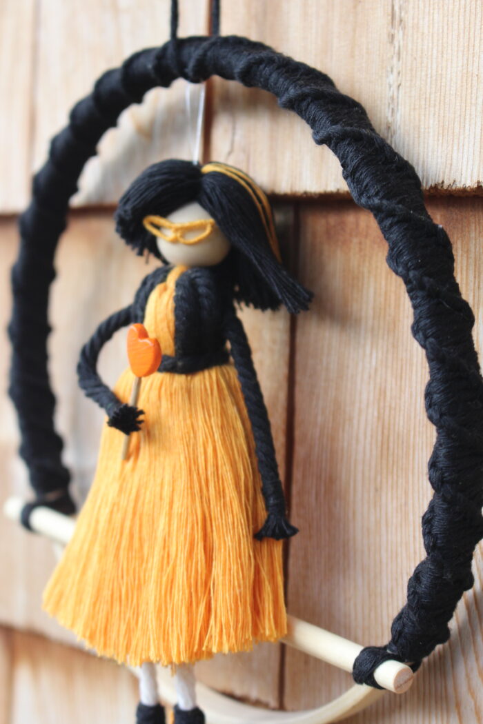 macrame doll black orange