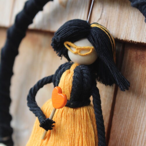 macrame doll black orange